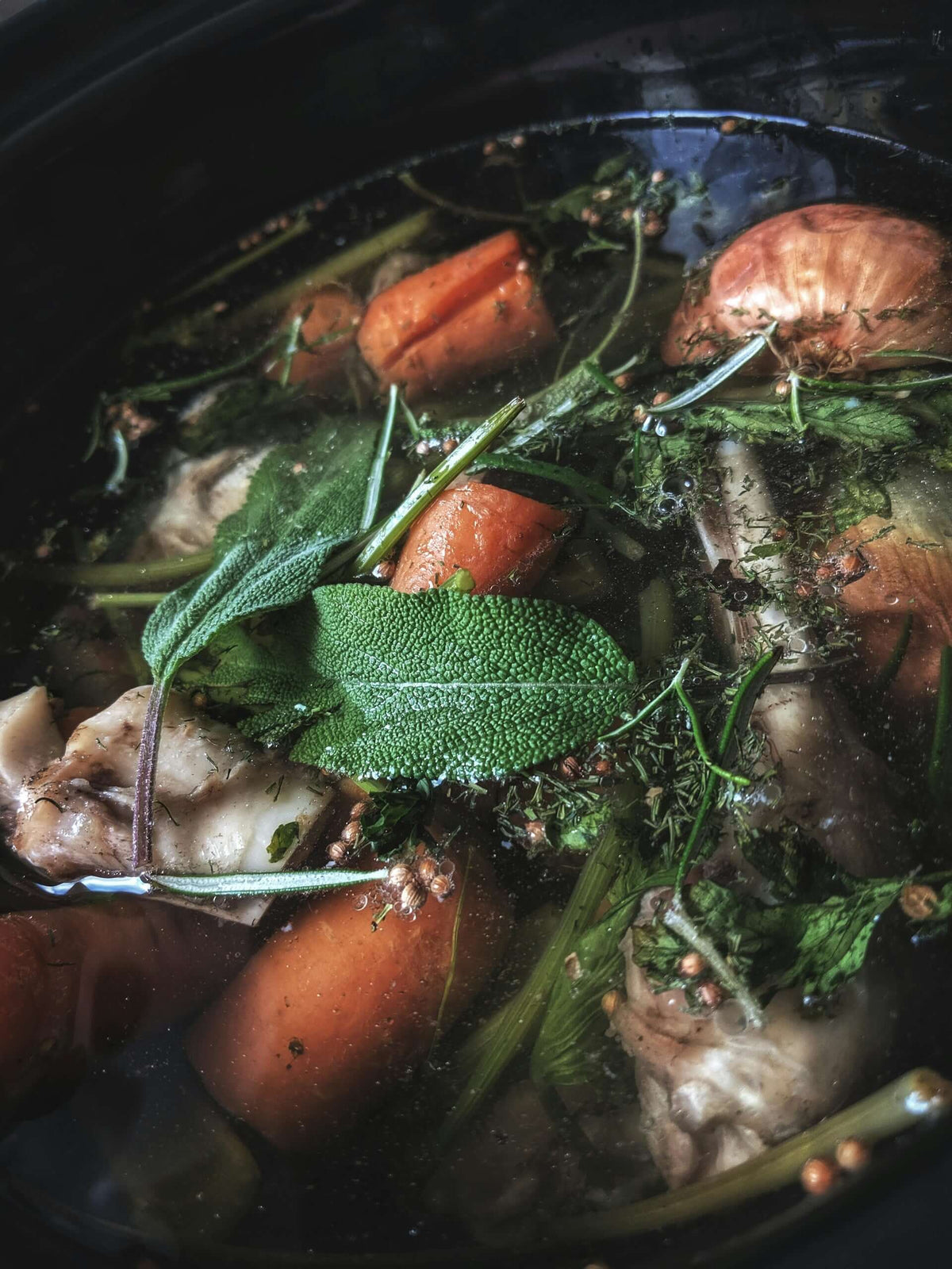 Turkey stock simmering with vegetables.