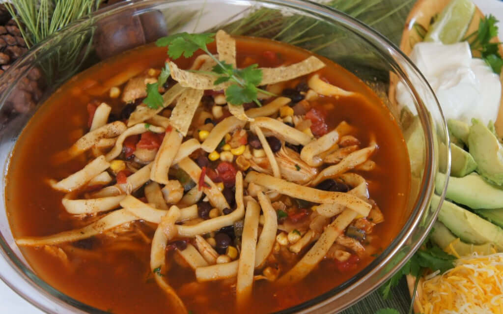 Tortilla Noodle Soup surrounded by fresh ingredients