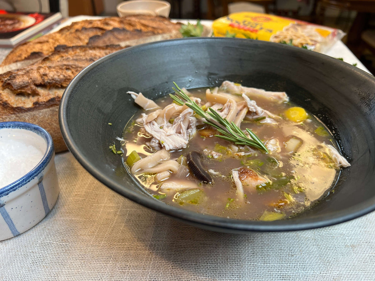 Hot chicken noodle soup with crusty bread