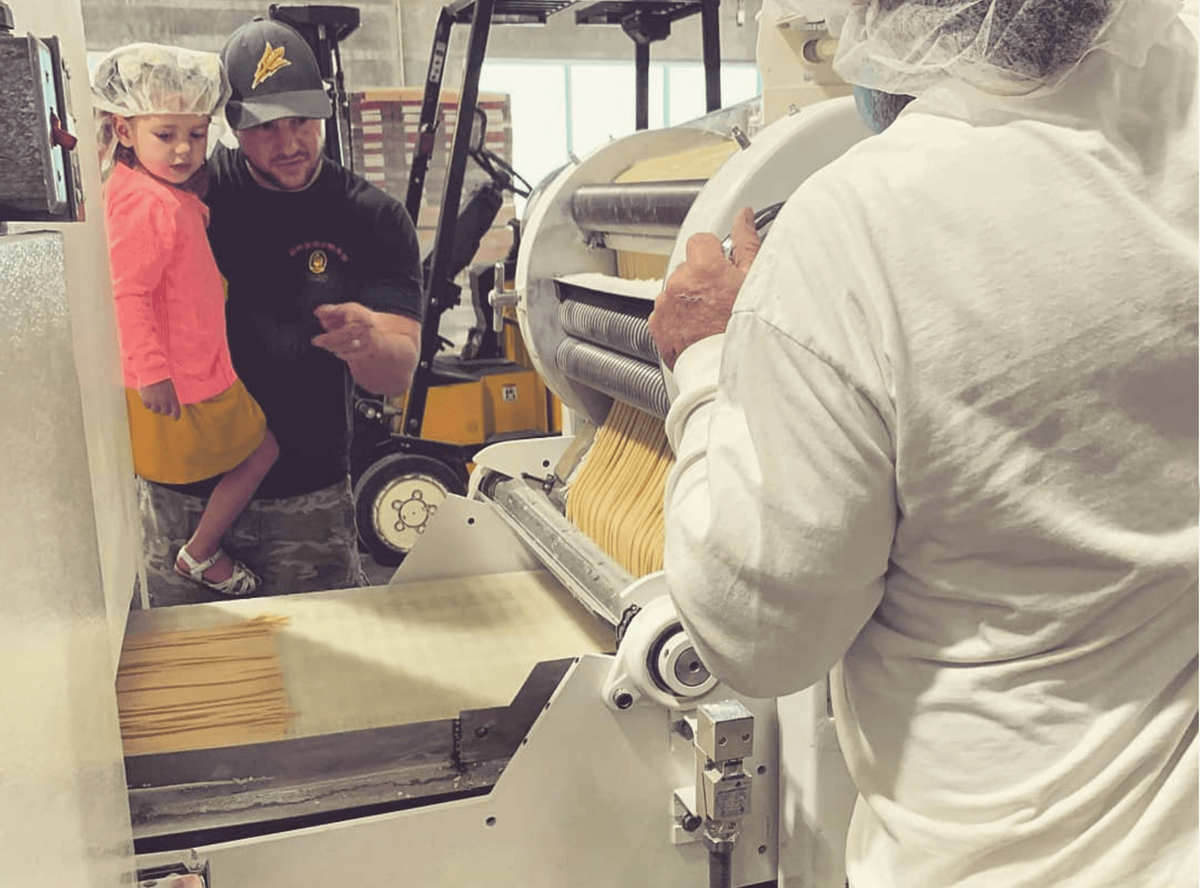 Young child watching the Making of Grandma's egg noodles.