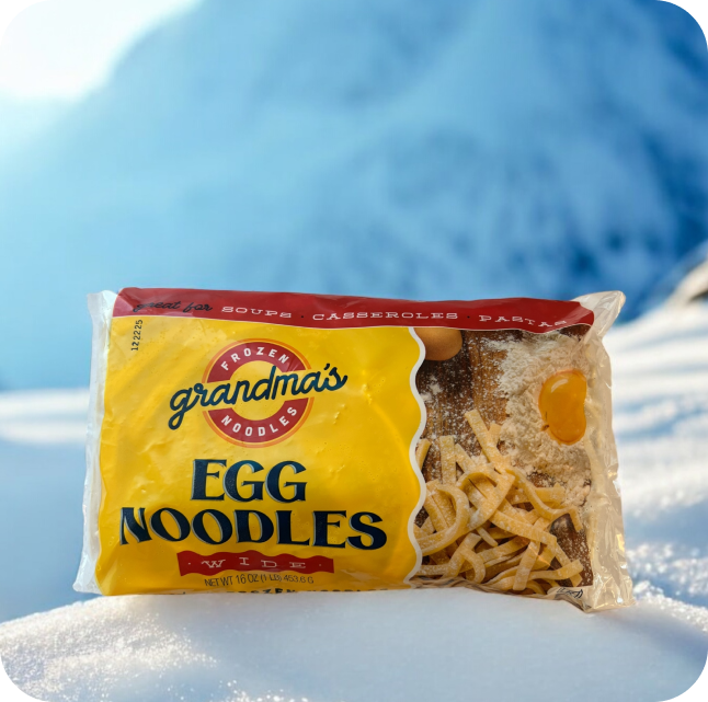 Grandma's egg noodles package in snow with mountains.